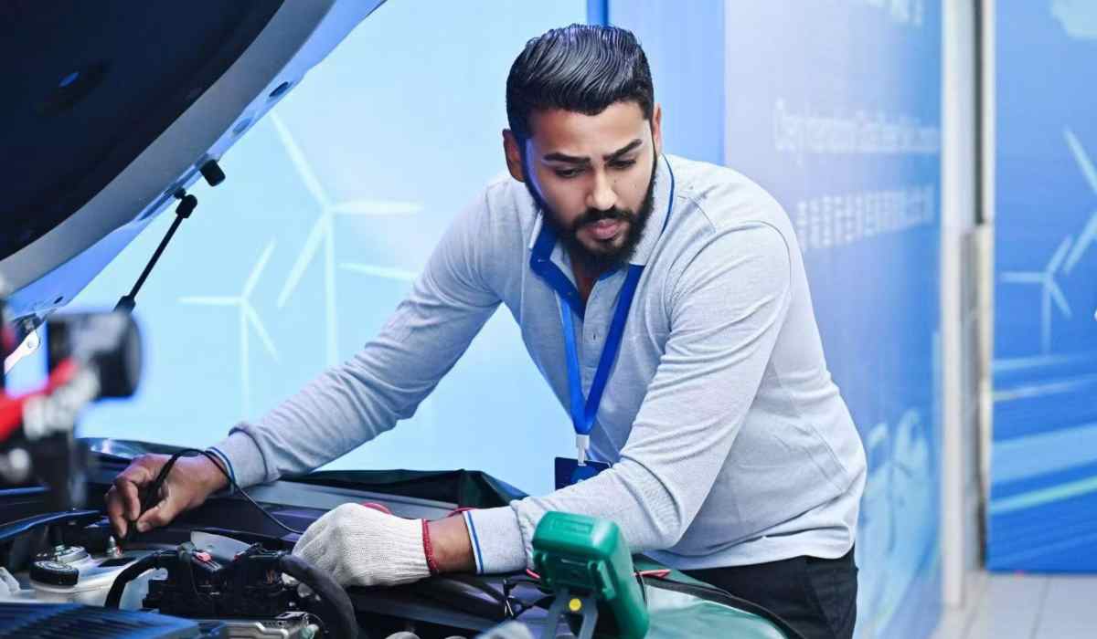 Técnico automotriz inspecciona el sistema de un vehículo durante una competencia internacional de habilidades de posventa.