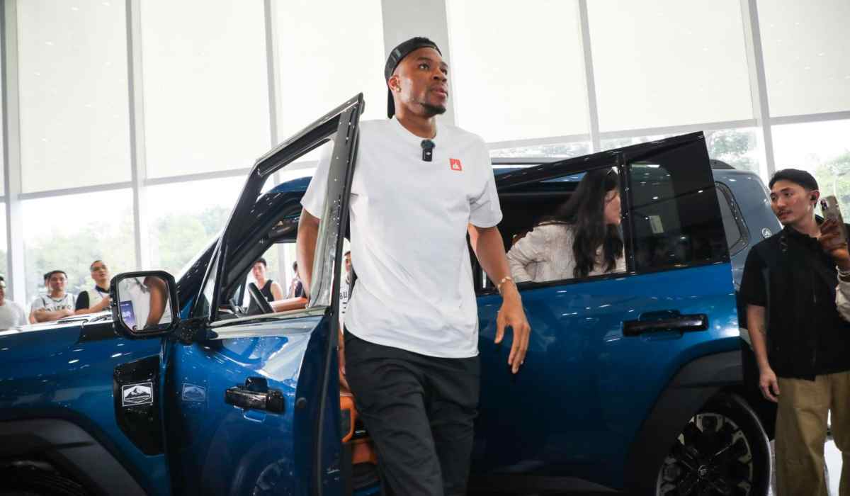 Giannis Antetokounmpo junto al SUV híbrido JETOUR G700 durante una visita a las instalaciones de la marca en China.