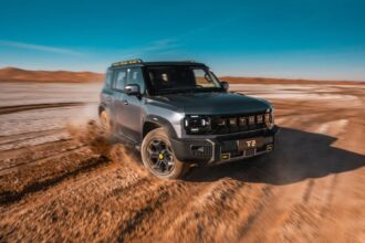 SUV todoterreno JETOUR T2 gris en movimiento sobre terreno desértico destacando la estrategia de expansión global Travel+.