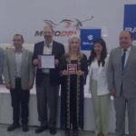Directivos de Moto Drive, Bajaj y representantes de la Secretaría de Economía sosteniendo el certificado y la placa de Hecho en México.