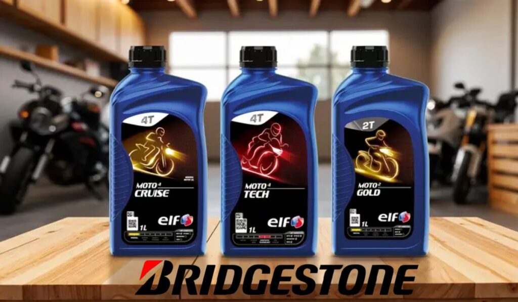 Tres envases de lubricantes para motor de la marca ELF junto al logotipo de Bridgestone sobre una mesa de madera.